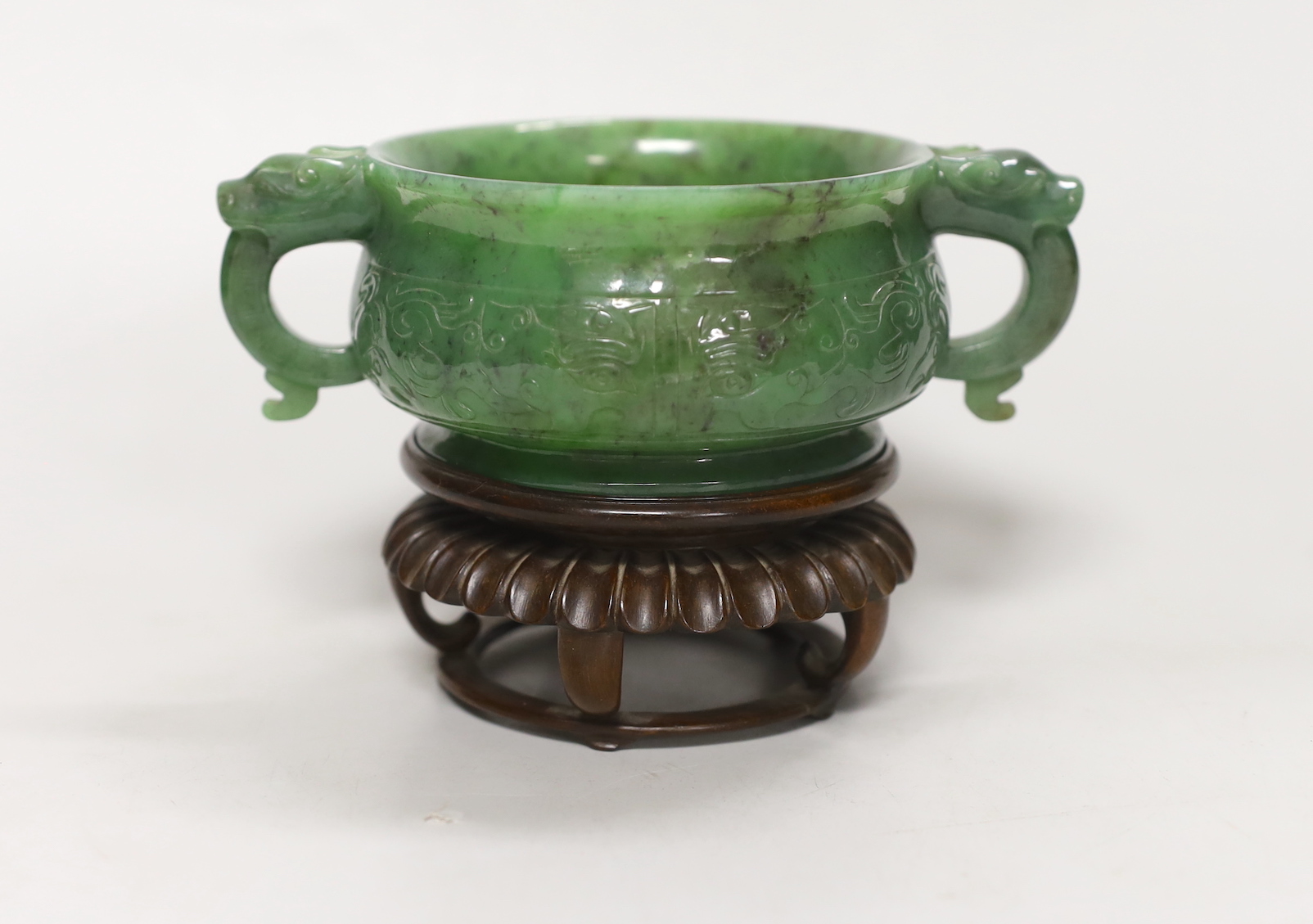 A Chinese archaistic green jade censer, wood stand. 10cm tall incl. stand